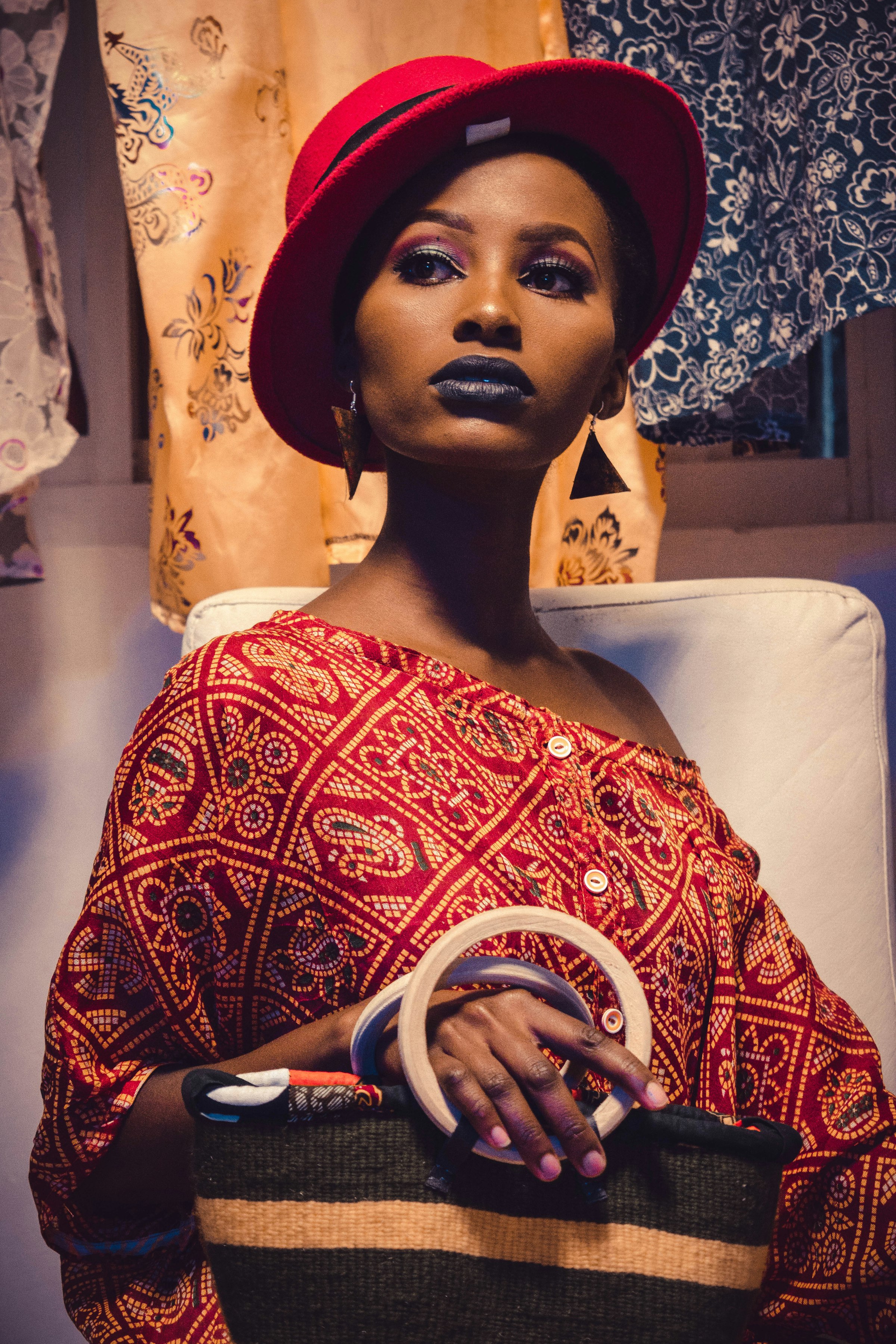 Woman in a red headwrap and patterned dress